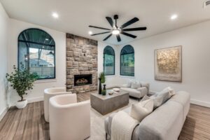 Renovated living room with stone fireplace and vaulted ceiling in DFW
