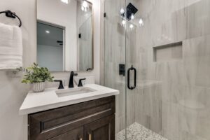 Bathroom renovation with tiled walk-in shower and modern vanity