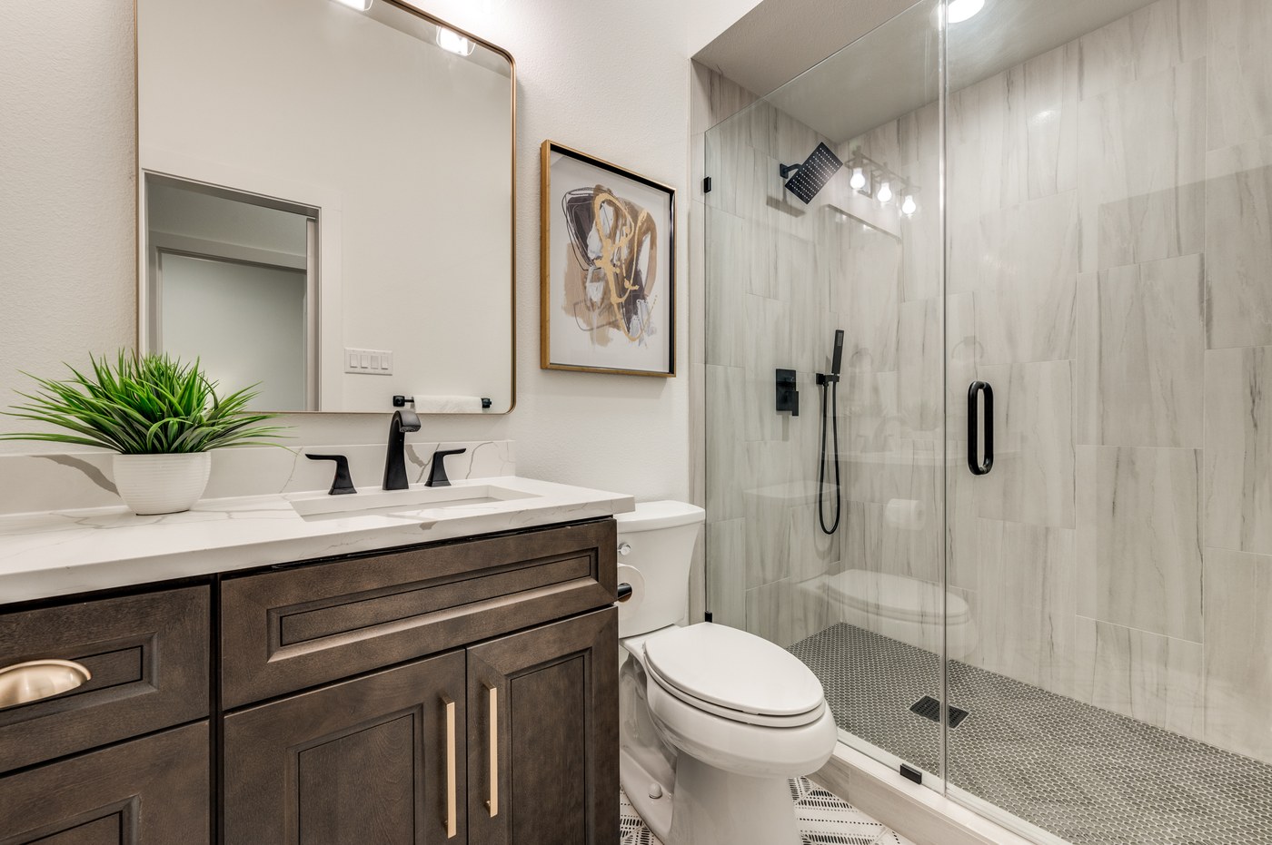 Bathroom renovation with frameless glass shower and modern vanity