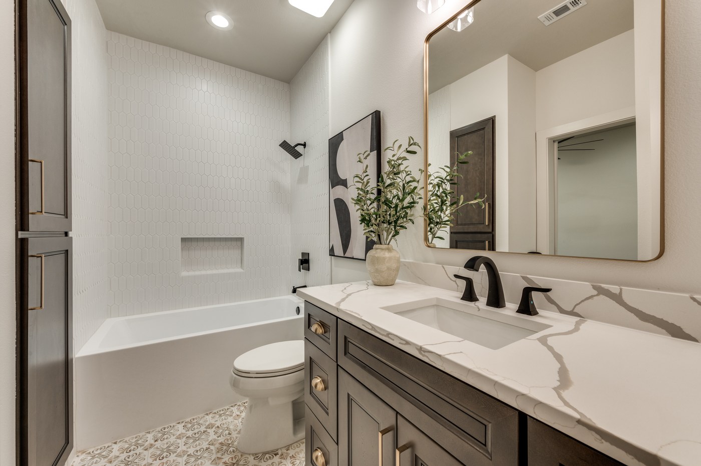 Bathroom vanity with updated mirror and lighting in a DFW remodel