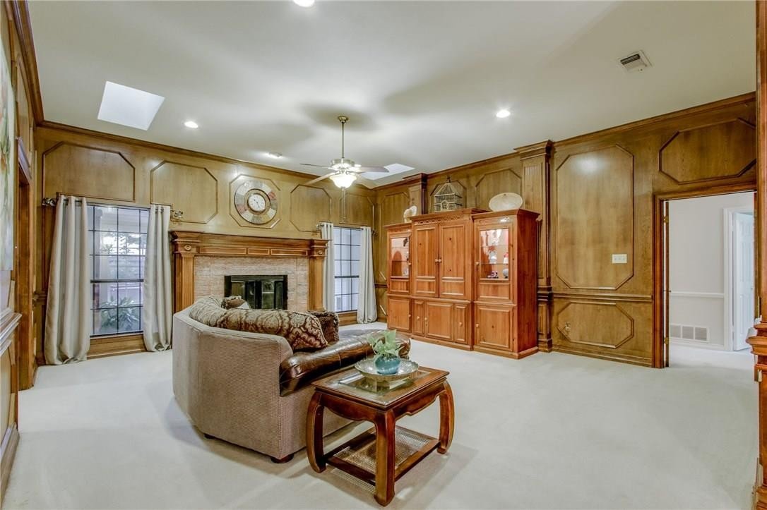 Wood-paneled living room before renovation in Carrollton, TX