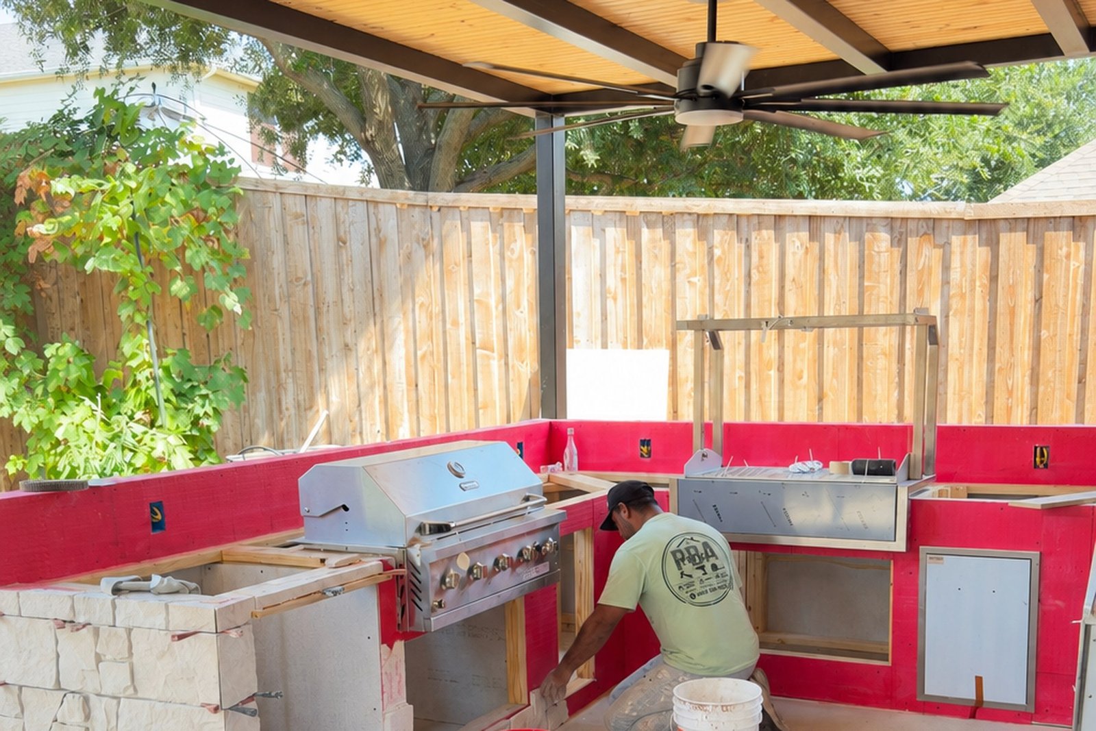 PBA Services crew building an outdoor kitchen under a covered patio