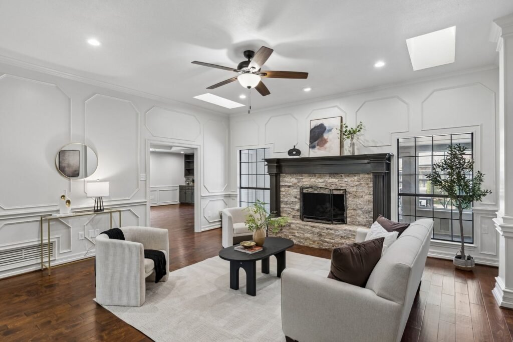 Family room after painting with wood paneling and trim painted white