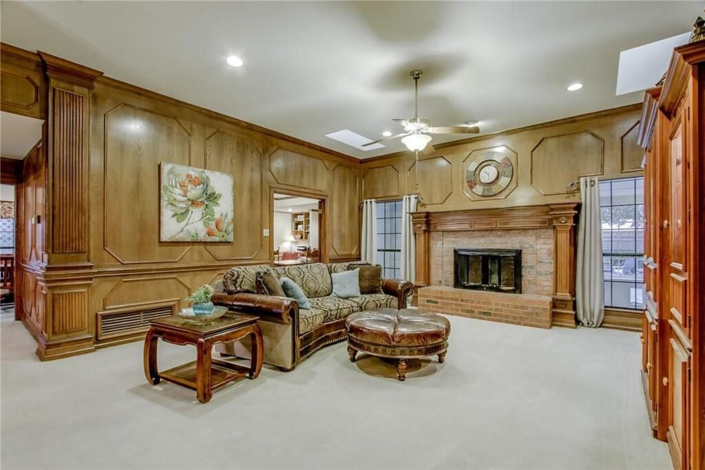 Family room before painting with dark stained oak wall paneling