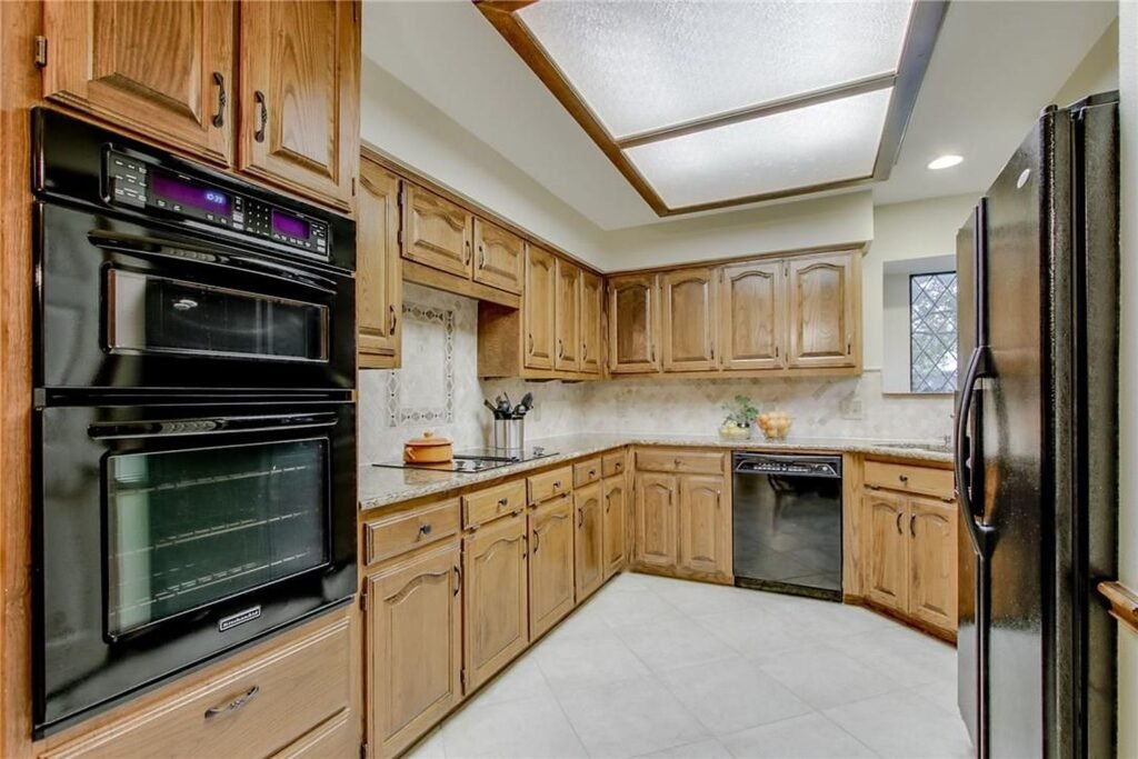 Kitchen before cabinet painting with original oak cabinets