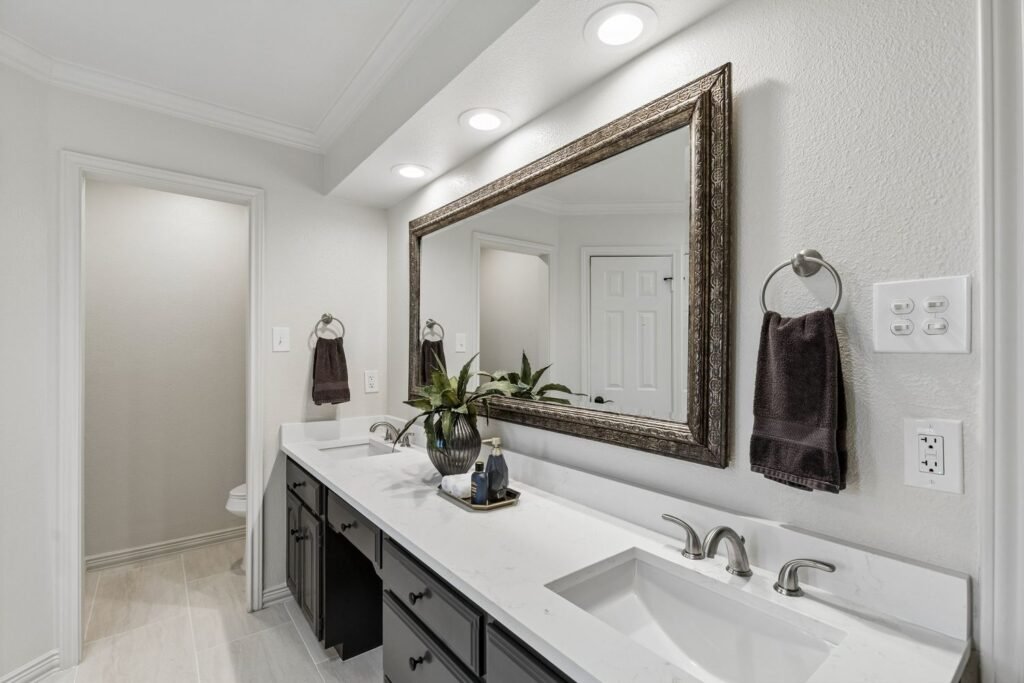 Primary bathroom after painting with white walls and painted charcoal vanity